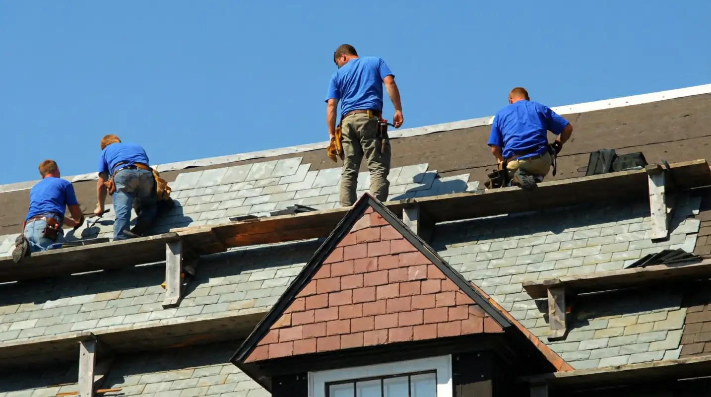 Roof replacement in progress with a team of professional contractors installing new shingles on a residential home in Austin, TX