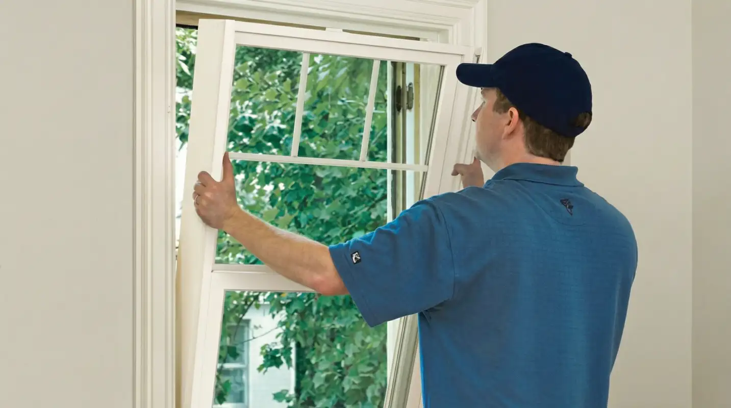 Professional contractors performing a residential window insulation and replacement service in Austin, TX